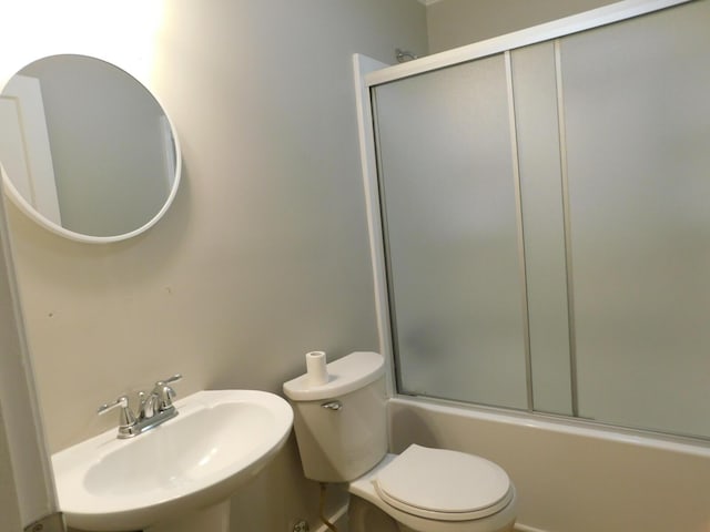 full bathroom featuring enclosed tub / shower combo, toilet, and sink