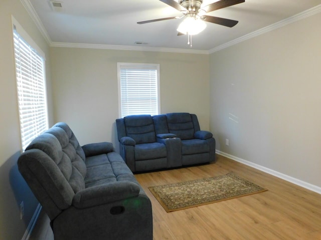 living room with hardwood / wood-style flooring, ornamental molding, and ceiling fan