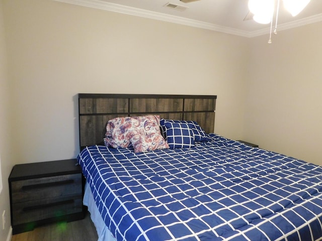 bedroom featuring crown molding, wood-type flooring, and ceiling fan