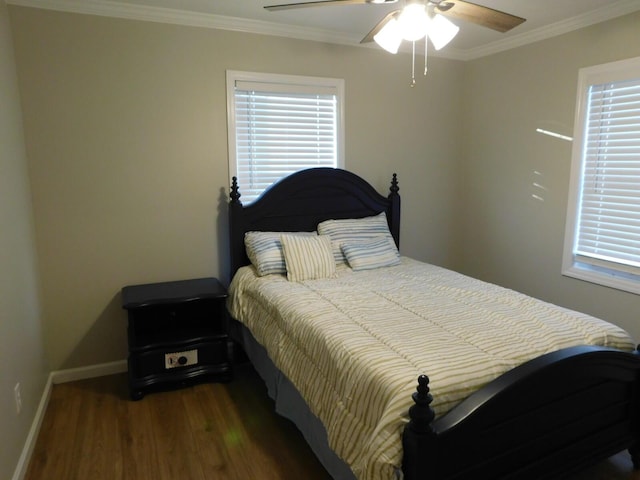 bedroom featuring ceiling fan, ornamental molding, and dark hardwood / wood-style floors