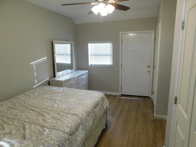 bedroom with lofted ceiling, dark wood-type flooring, and ceiling fan