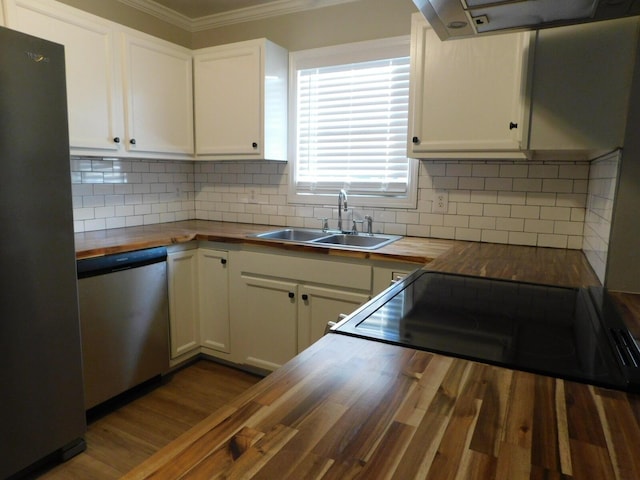 kitchen featuring stainless steel appliances, white cabinetry, sink, and butcher block countertops