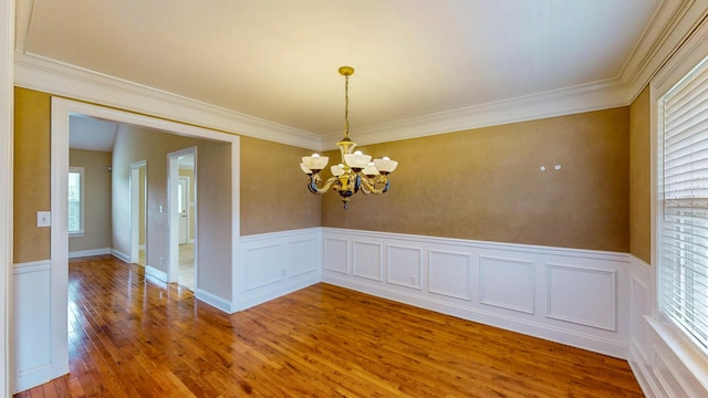 117 Windswept Dr NE, Cleveland, TN 37312 - spare room featuring healthy amount of natural light, wood finished floors, a chandelier, crown molding, and a wainscoted wall