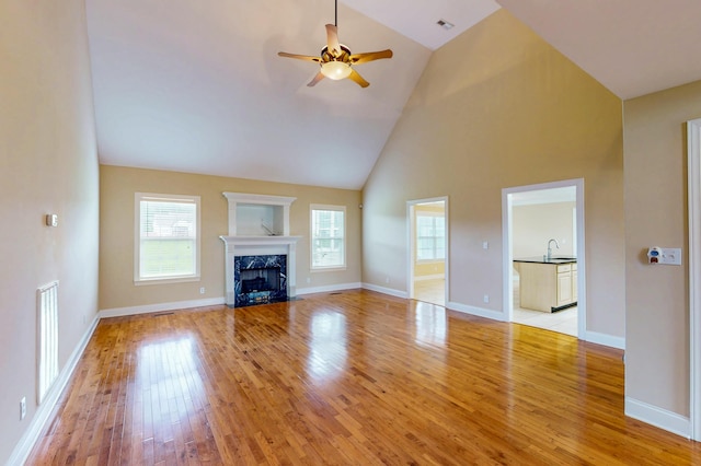 117 Windswept Dr NE, Cleveland, TN 37312 - unfurnished living room featuring wood finished floors, a ceiling fan, high vaulted ceiling, and a premium fireplace