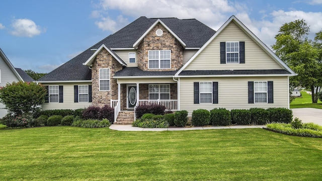 117 Windswept Dr NE, Cleveland, TN 37312 - view of front of property featuring stone siding, a front lawn, covered porch, and roof with shingles
