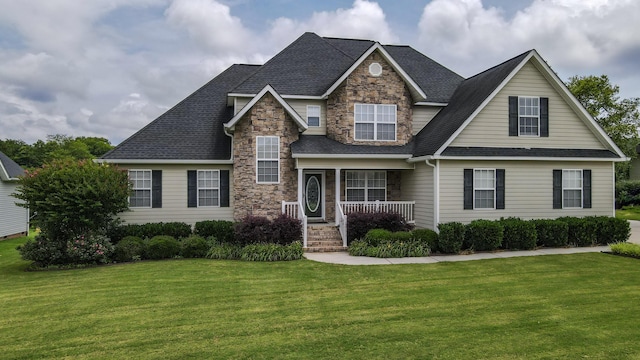 117 Windswept Dr NE, Cleveland, TN 37312 - view of front of property featuring stone siding, covered porch, a front lawn, and roof with shingles