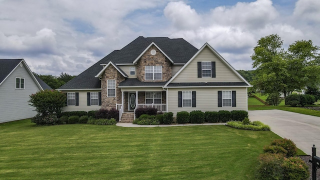 117 Windswept Dr NE, Cleveland, TN 37312 - view of front facade featuring stone siding, covered porch, a front lawn, and a shingled roof