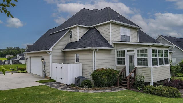 117 Windswept Dr NE, Cleveland, TN 37312 - rear view of house with a shingled roof, concrete driveway, a garage, and entry steps