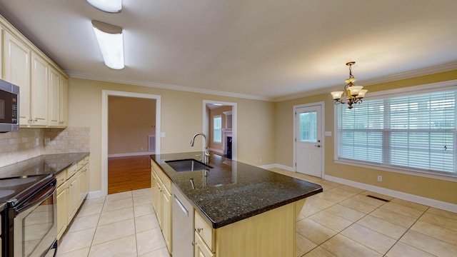 117 Windswept Dr NE, Cleveland, TN 37312 - kitchen featuring appliances with stainless steel finishes, light tile patterned flooring, a center island with sink, decorative backsplash, and crown molding