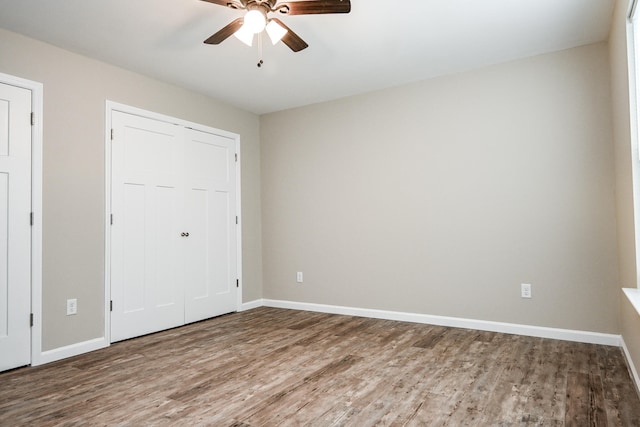 unfurnished bedroom featuring hardwood / wood-style floors and ceiling fan