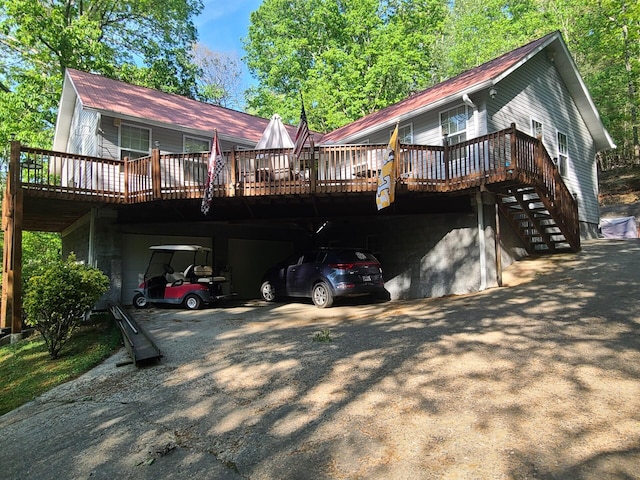 7054 Ski Club Rd, Harrison, TN 37341 - back of property with a deck, driveway, and stairway