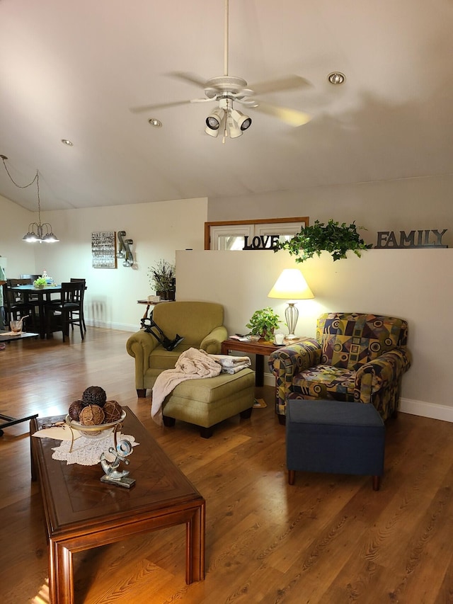 7054 Ski Club Rd, Harrison, TN 37341 - living room featuring lofted ceiling, a ceiling fan, wood finished floors, baseboards, and a chandelier