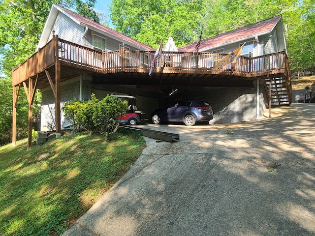 7054 Ski Club Rd, Harrison, TN 37341 - view of front facade with a wooden deck, stairs, asphalt driveway, and an attached carport