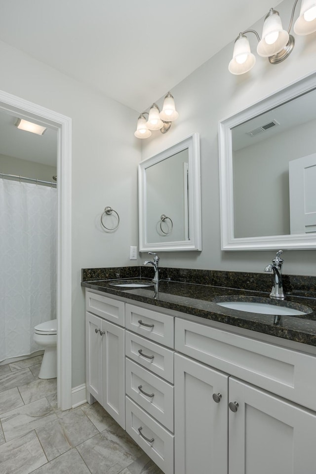 bathroom with toilet and vanity