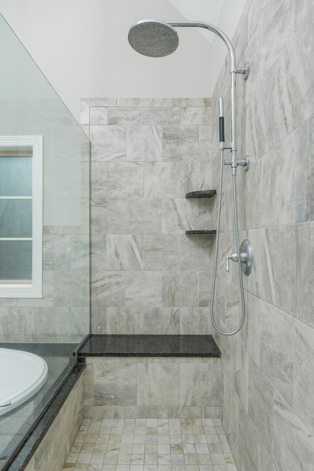 bathroom with a tile shower