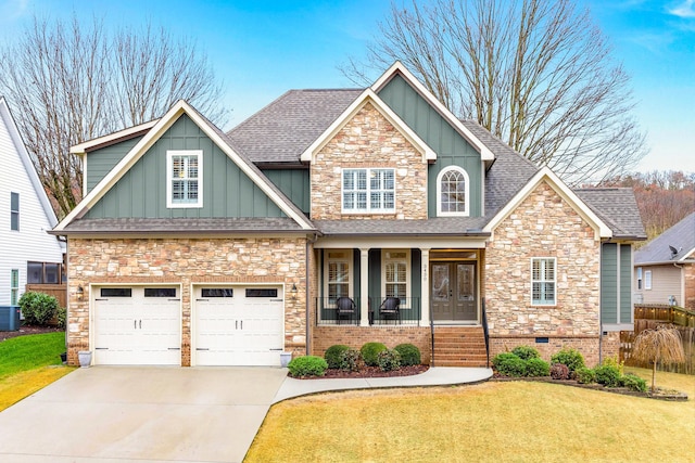 craftsman inspired home featuring a front lawn, a porch, and a garage