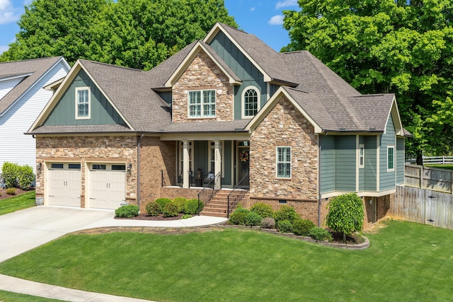 craftsman inspired home with a garage, a front yard, and a porch