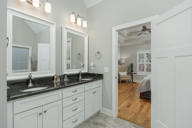 bathroom featuring ceiling fan, crown molding, hardwood / wood-style flooring, and vanity