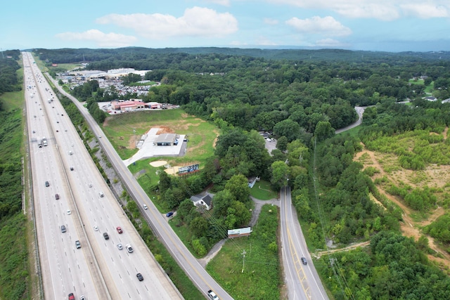 drone / aerial view featuring a wooded view