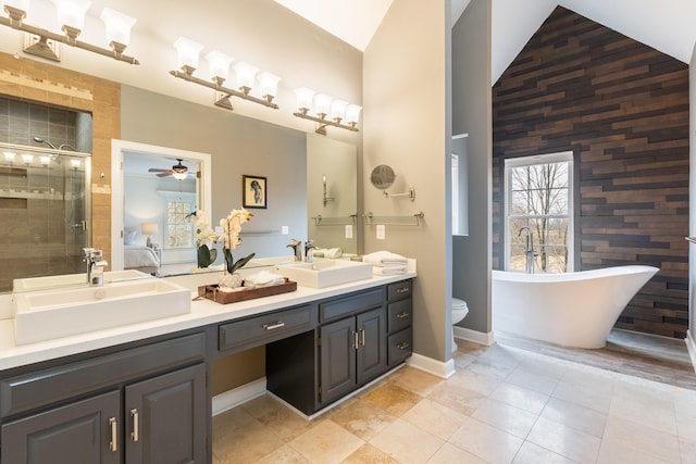 full bathroom featuring ceiling fan, tile patterned flooring, toilet, vanity, and independent shower and bath