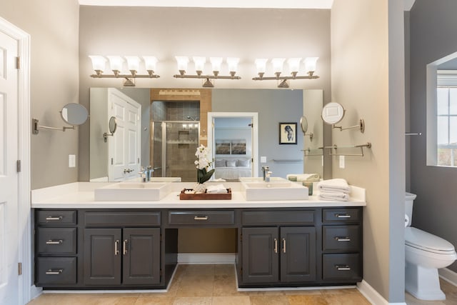 bathroom with vanity, toilet, and an enclosed shower