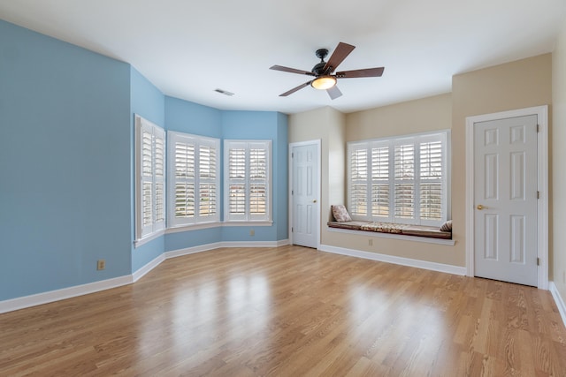 unfurnished room with light hardwood / wood-style floors, plenty of natural light, and ceiling fan