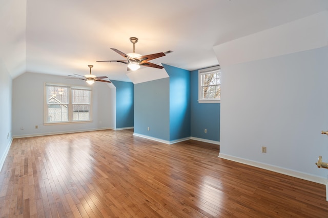 unfurnished living room with ceiling fan, wood-type flooring, and lofted ceiling