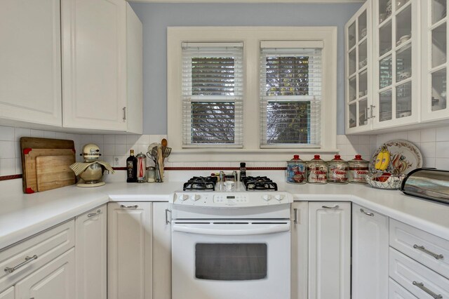 431 Highland Ave NW, Cleveland, TN 37311 - kitchen with gas range gas stove, tasteful backsplash, white cabinetry, and light countertops