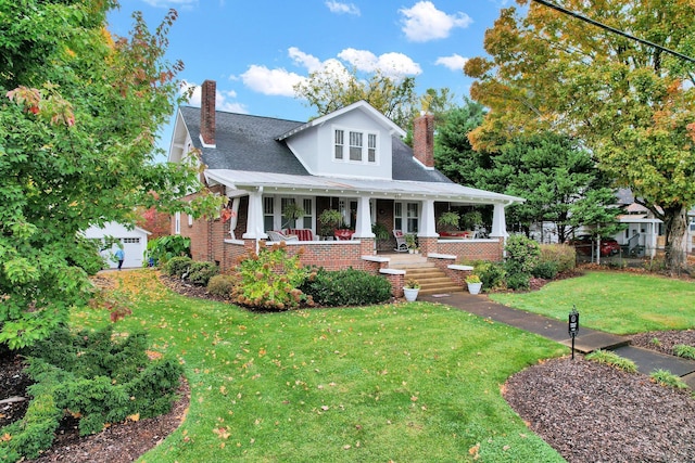 431 Highland Ave NW, Cleveland, TN 37311 - view of front of house featuring a chimney, covered porch, a front yard, and brick siding