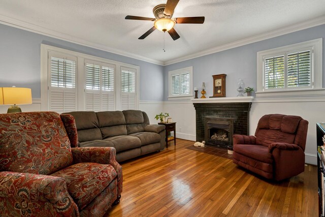 431 Highland Ave NW, Cleveland, TN 37311 - living room with hardwood / wood-style floors, a ceiling fan, ornamental molding, and a fireplace
