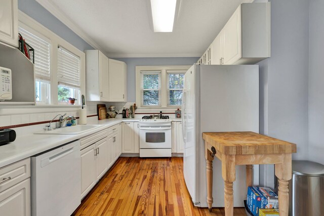 431 Highland Ave NW, Cleveland, TN 37311 - kitchen featuring white appliances, light countertops, light wood-type flooring, white cabinetry, and crown molding