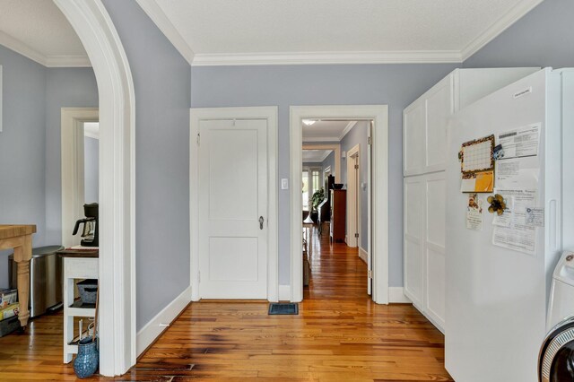 431 Highland Ave NW, Cleveland, TN 37311 - corridor featuring ornamental molding, arched walkways, light wood-type flooring, and washer / clothes dryer