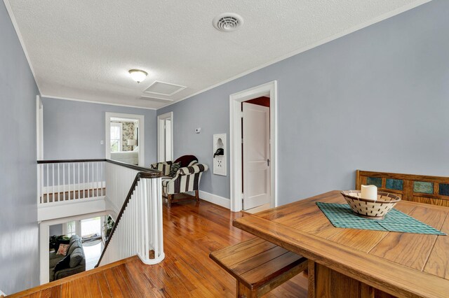 431 Highland Ave NW, Cleveland, TN 37311 - hallway featuring an upstairs landing, a textured ceiling, attic access, wood finished floors, and ornamental molding