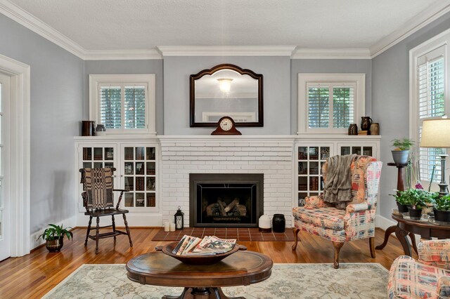 431 Highland Ave NW, Cleveland, TN 37311 - living area with wood finished floors, crown molding, and a brick fireplace