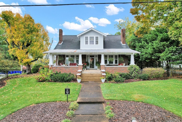 431 Highland Ave NW, Cleveland, TN 37311 - view of front of home with covered porch, a chimney, brick siding, and a front yard