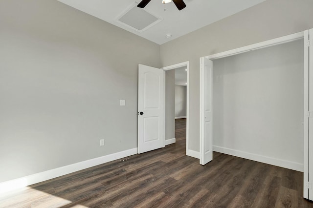 unfurnished bedroom with ceiling fan and dark wood-type flooring