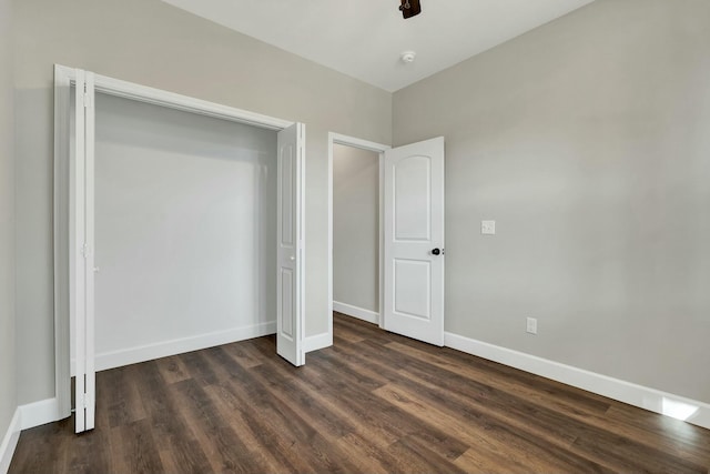 unfurnished bedroom featuring ceiling fan and dark hardwood / wood-style flooring