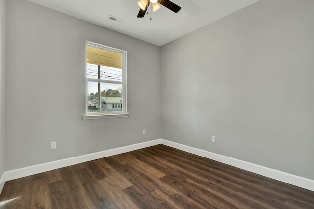 empty room featuring ceiling fan and dark wood-type flooring