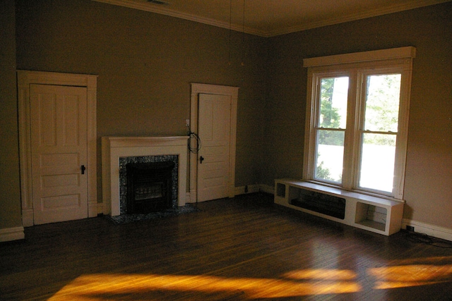 unfurnished living room featuring a fireplace, baseboards, crown molding, and wood finished floors