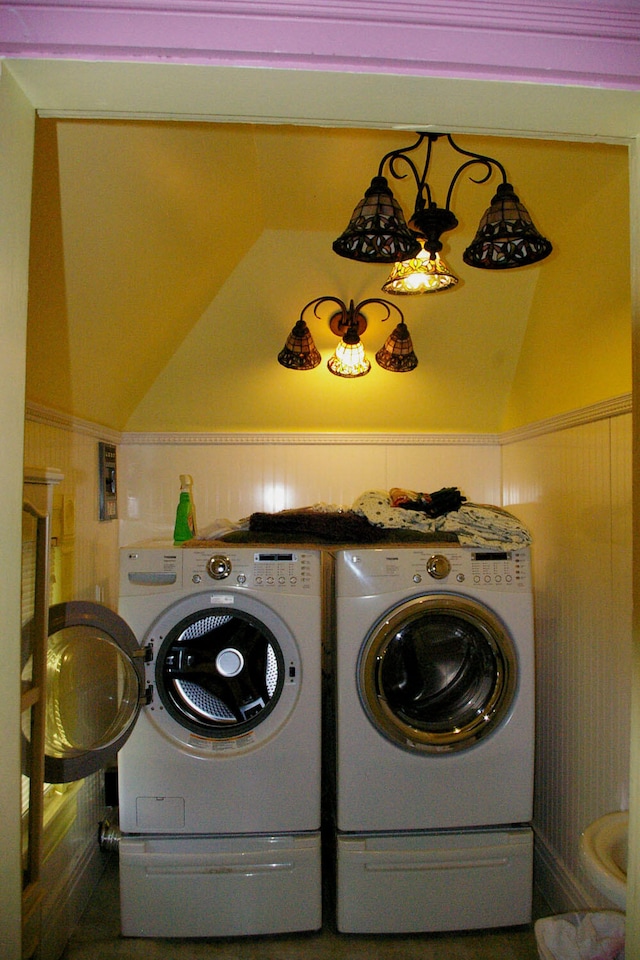 washroom with laundry area, separate washer and dryer, and wainscoting