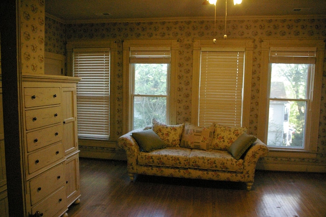 living area featuring crown molding, dark wood-style floors, and wallpapered walls