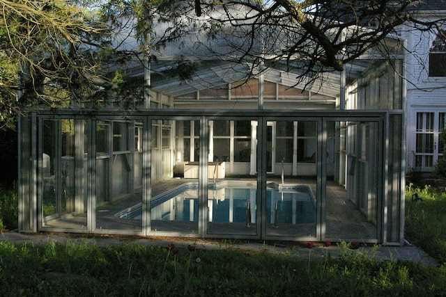 outdoor pool featuring a sunroom