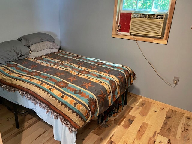 bedroom featuring hardwood / wood-style flooring and cooling unit