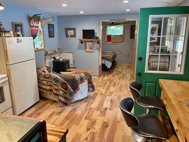 interior space with light hardwood / wood-style floors, a wealth of natural light, and cooling unit