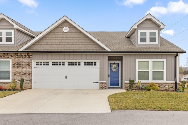 view of front of property with a garage and a front lawn