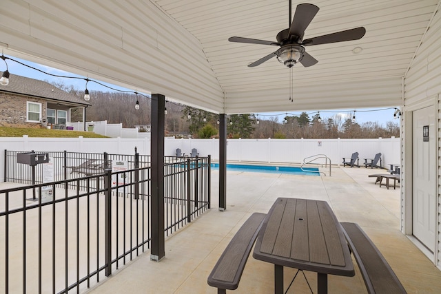 view of patio / terrace featuring a fenced in pool and ceiling fan