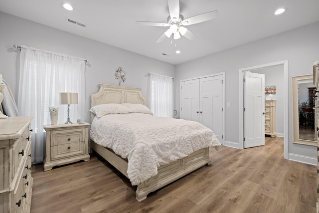 bedroom featuring a closet, ceiling fan, and light hardwood / wood-style flooring