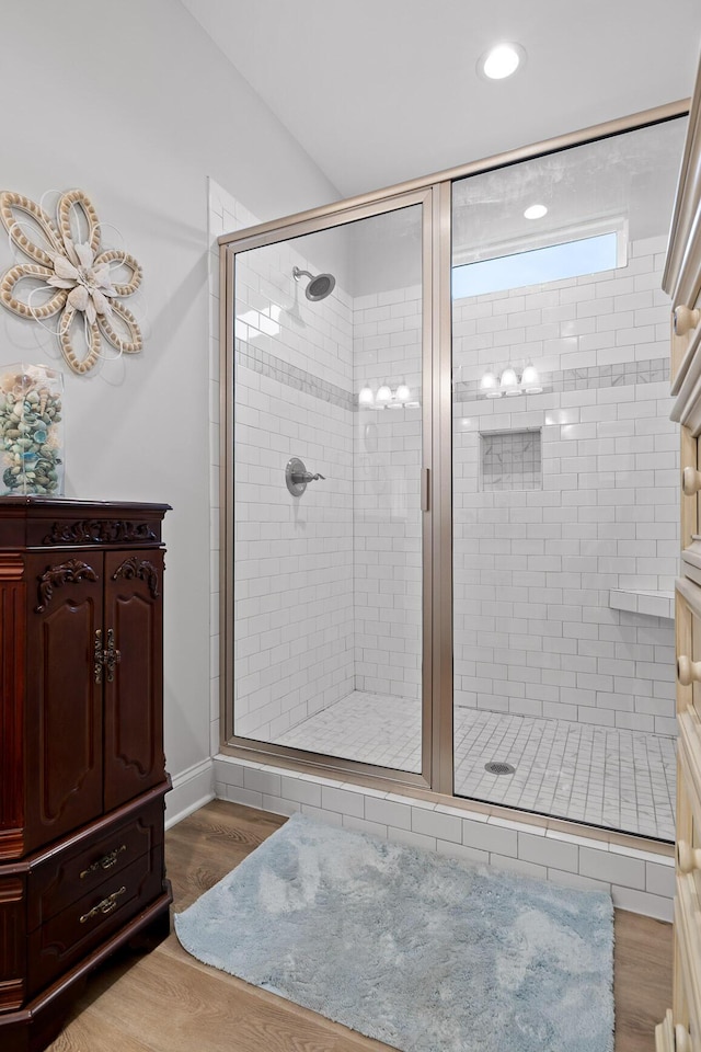 bathroom featuring hardwood / wood-style flooring and an enclosed shower