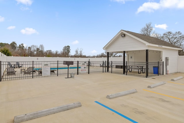 surrounding community featuring a swimming pool and a patio area