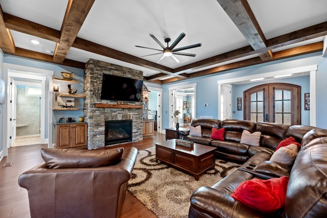 living room with french doors, coffered ceiling, wood-type flooring, beamed ceiling, and a fireplace